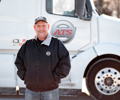 ATS driver with a white semi-truck; best dry van companies; Anderson Trucking Service