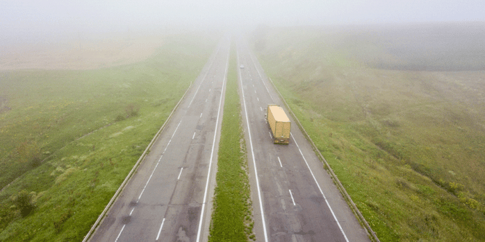 Aerial view of a truck traveling on a highway; trucking home time; ATS