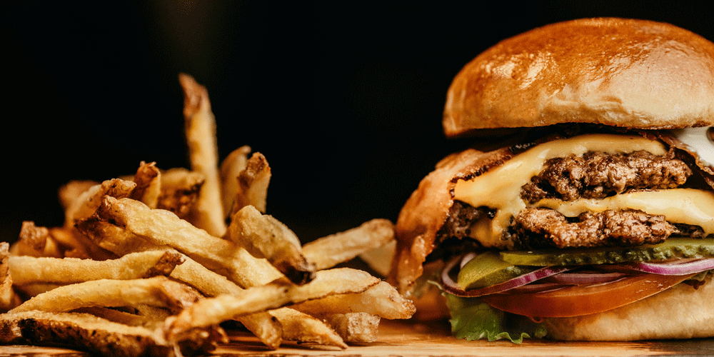 Photo of double cheeseburger with French fries; Per Diem pay; how do truck drivers get paid; Anderson Trucking Service; ATS