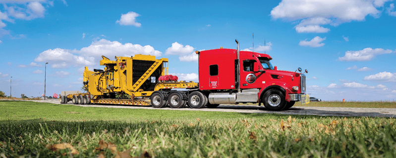 ATS step-deck trailer hauling construction freight, heavy haul, OTR pay