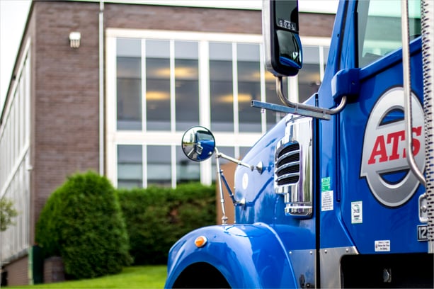 Close-up of ATS semi-truck cab parked outside Anderson Trucking Service headquarters in St. Cloud, MN; truck driver orientation guide