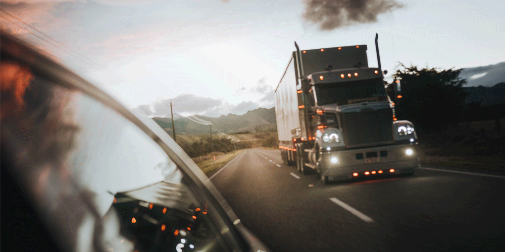 Semi-truck In Rearview Mirror
