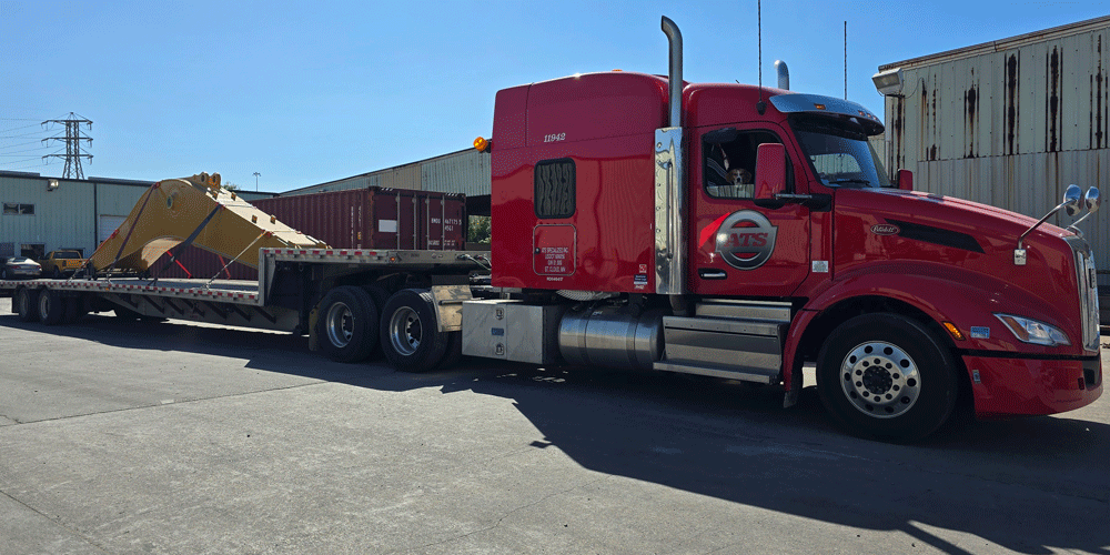 Red semi-truck hauling crane arm.