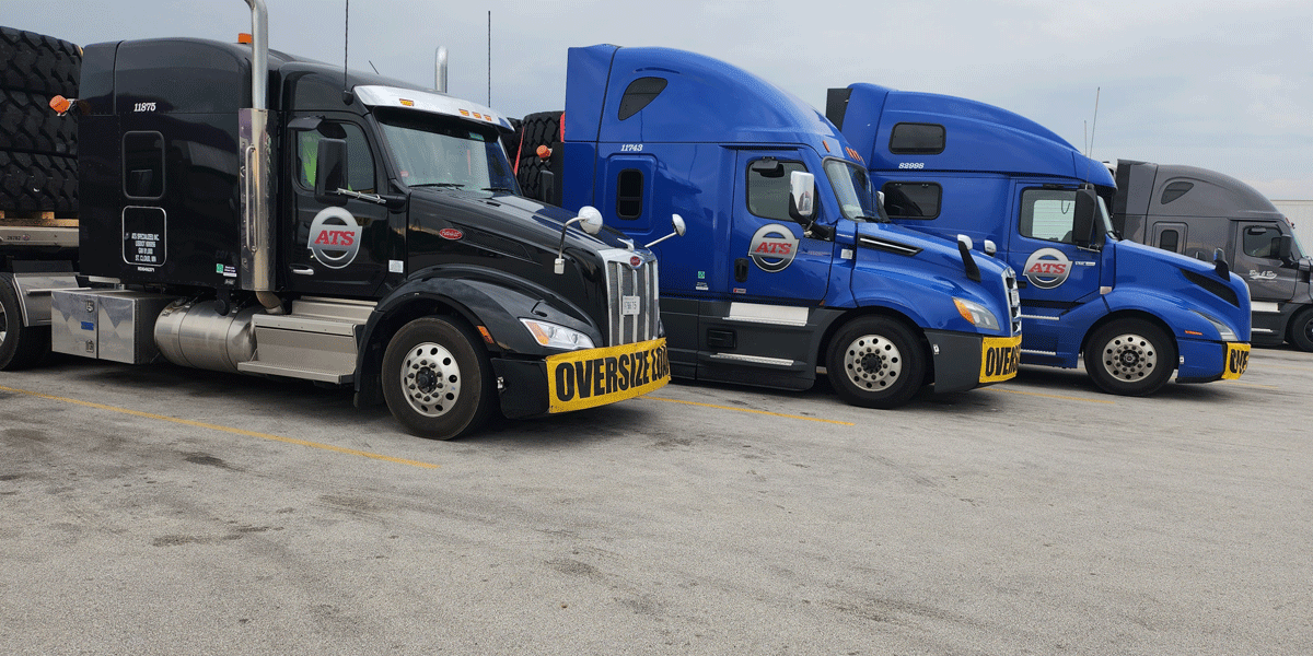 Several ATS semi-trucks parked in a row