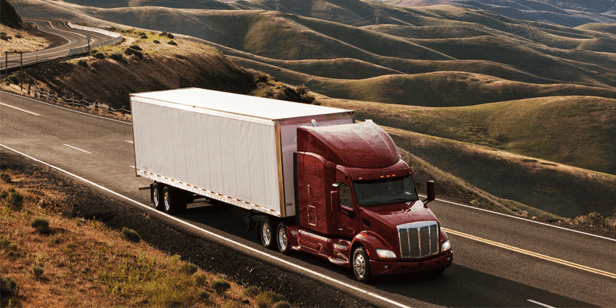 Commercial truck driving through farmlands