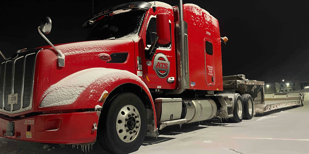 A dusting of snow on a red ATS truck.