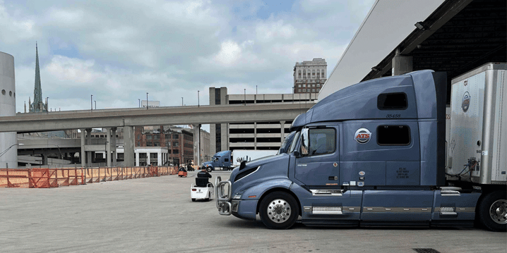 Semi-truck with van trailer backed up to dock, ATS, company driver jobs, Anderson Trucking Service