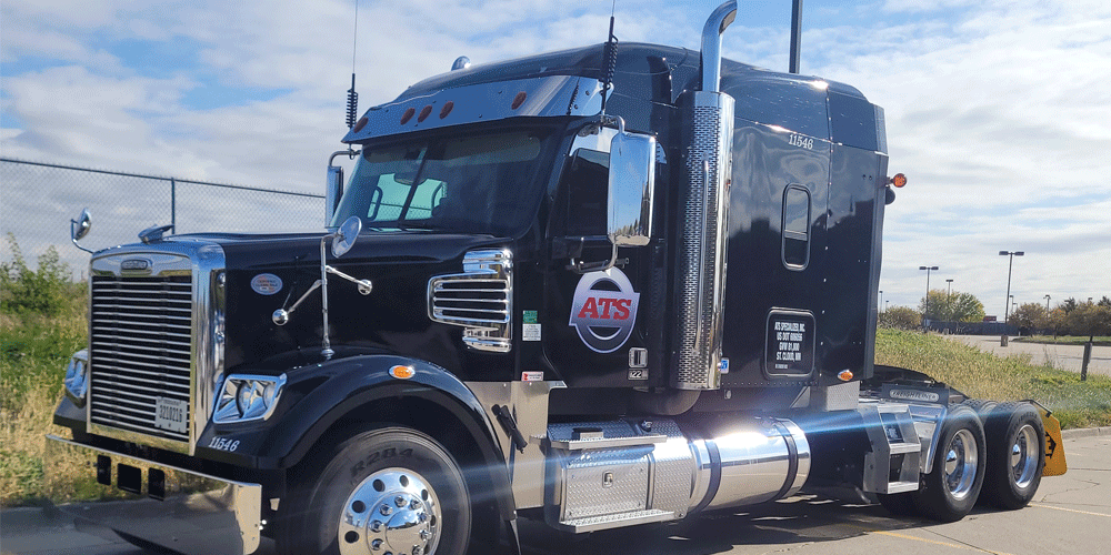 Black ATS semi-truck parked in a lot without a trailer attached.