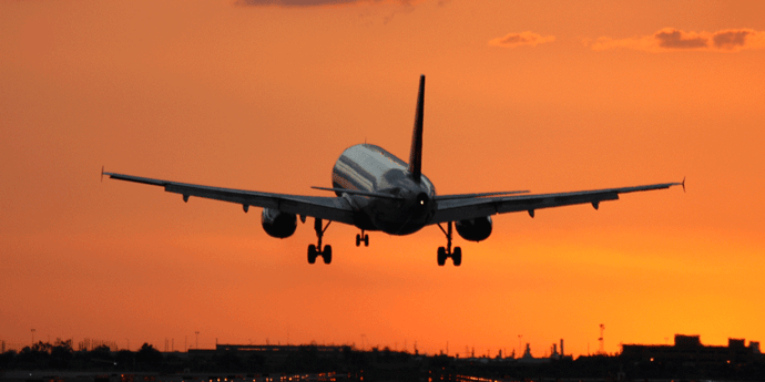 An airplane takes off at sunrise; truck driver orientation guide; ATS; Anderson Trucking Service