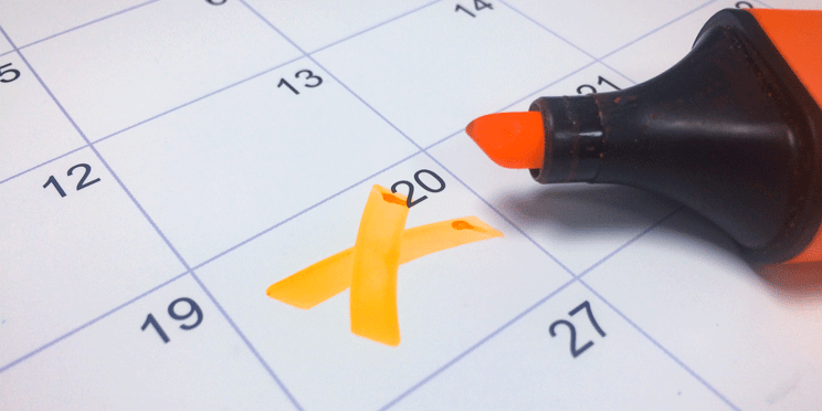 An orange highlighter marks off a date on a calendar