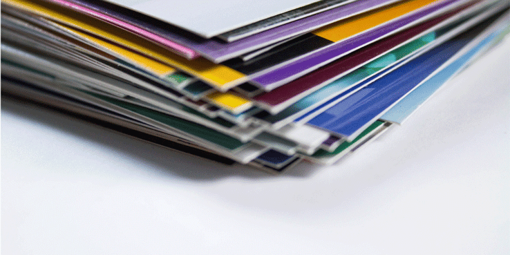 A stack of folders and papers sits on table