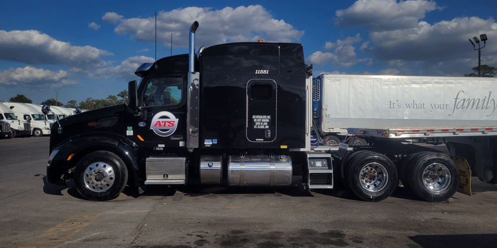 Black ATS tractor parked in a lot of other trucks. There's no attached trailer.