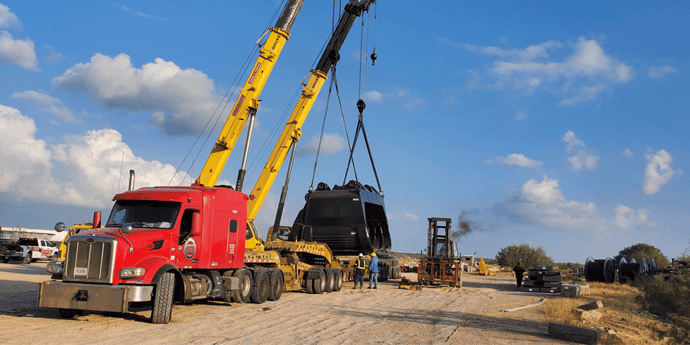 ATS semi-truck hauling two large construction cranes; Anderson Trucking Service; highest paying FTL trucking companies
