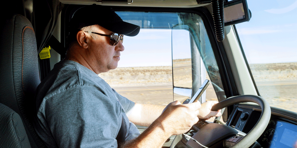 Truck driver on cell phone while driving.