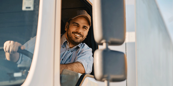Truck driver leaning out his window and smiling