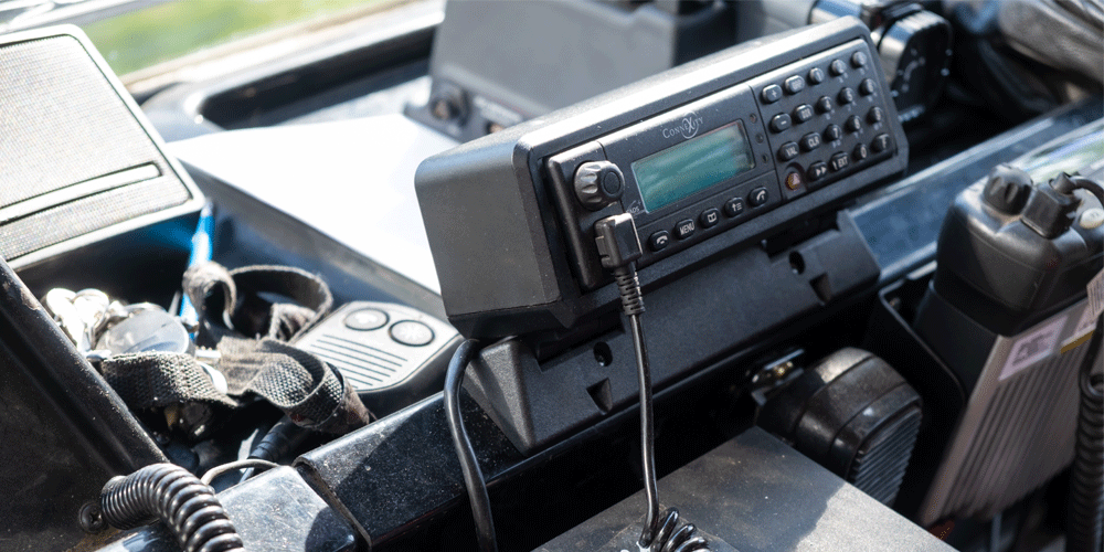 Portable radio set up on dashboard.