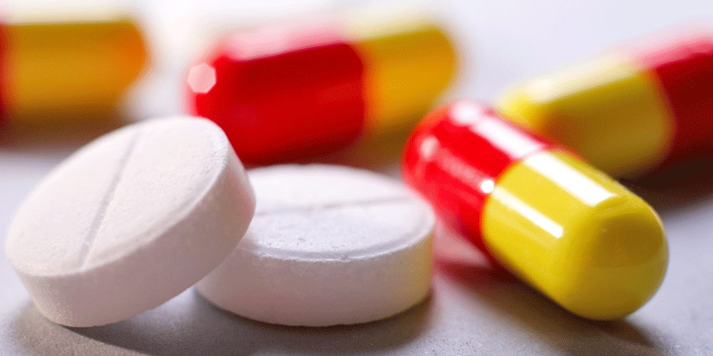 White circular pills and red and yellow oblong pills.