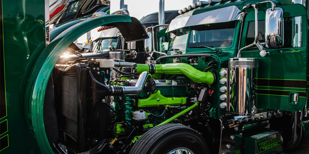 Open shiny green semi-truck hood.