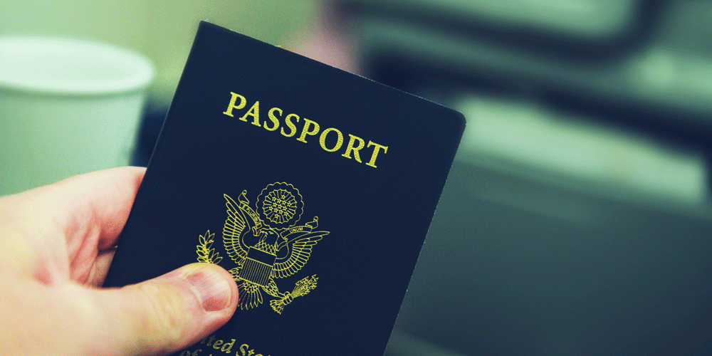Close up of man holding passport.