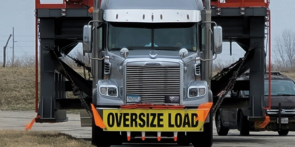 Front view of semi-truck hauling an oversize load.