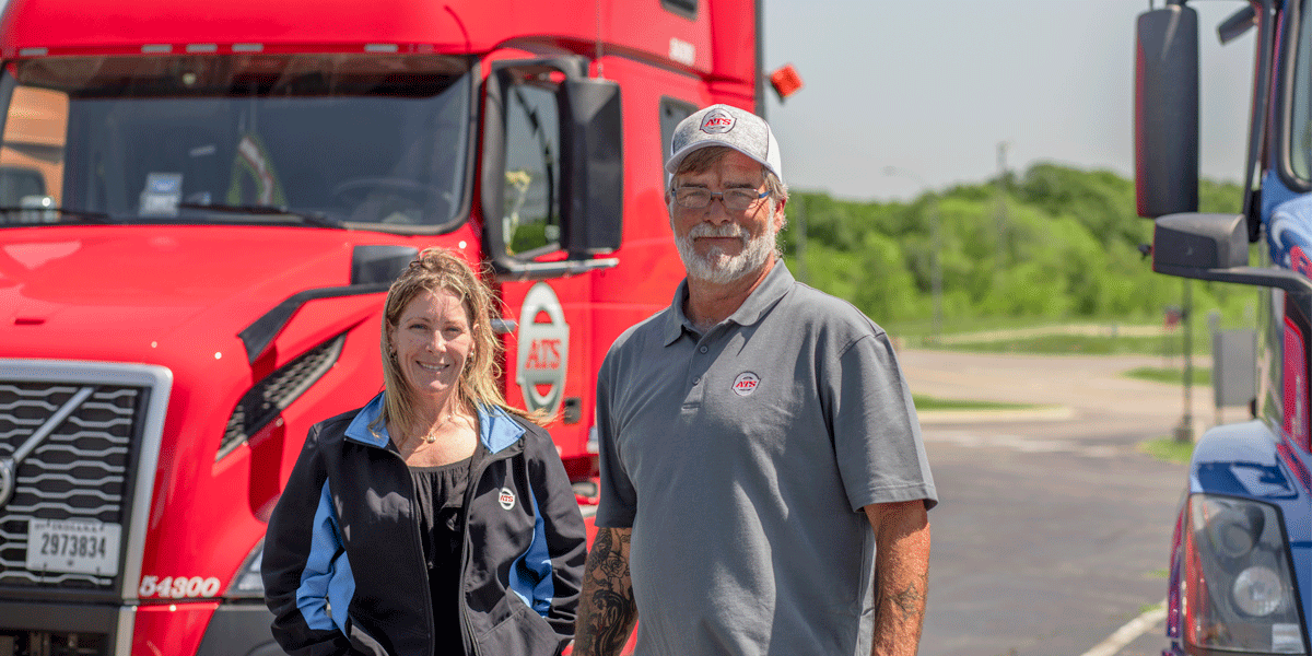 ATS driver with fleet manager Vicki standing in front of his truck.