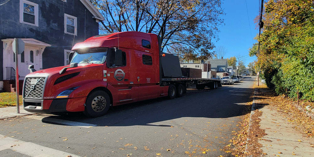 Semi-truck parked at a narrow street at home.