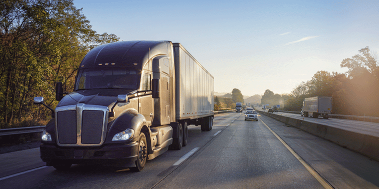Tractor trailer driving down two-lane highway.