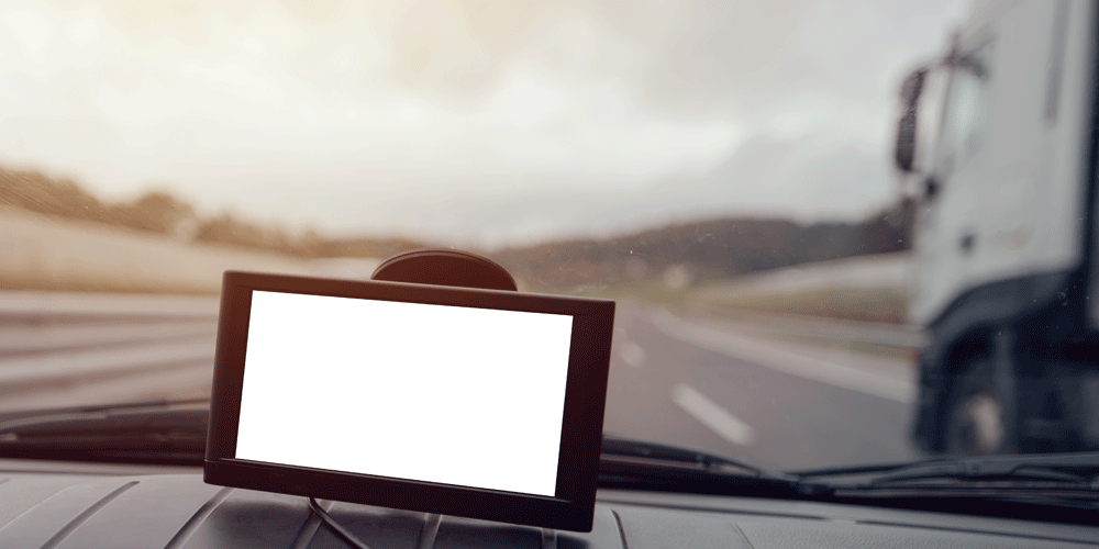 Blank GPS mounted on dashboard. The road is seen in the background.