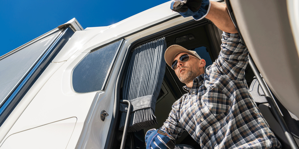 Truck driver resting in his cab.