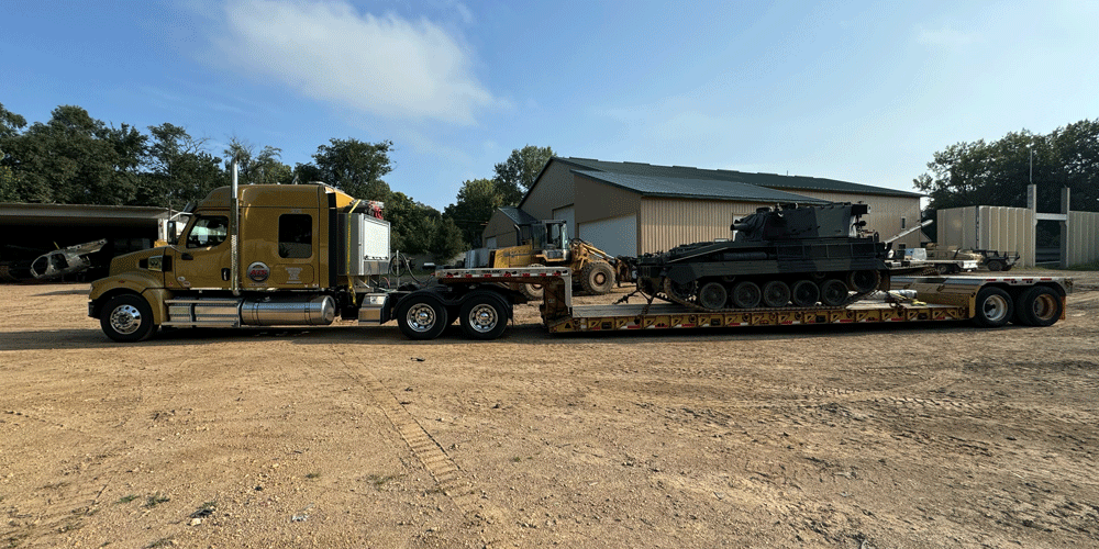 Tank on a step-deck trailer.