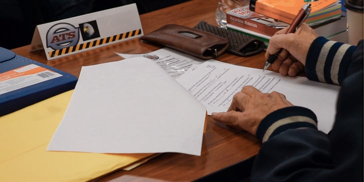 A driver fills out forms during ATS driver orientation