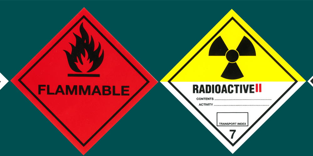Hazardous signs. One says flammable and one says radioactive ||.
