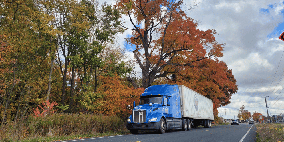 An ATS truck traveling against autumn foliage