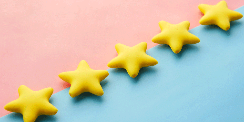 5 gold stars on a pink and blue background.