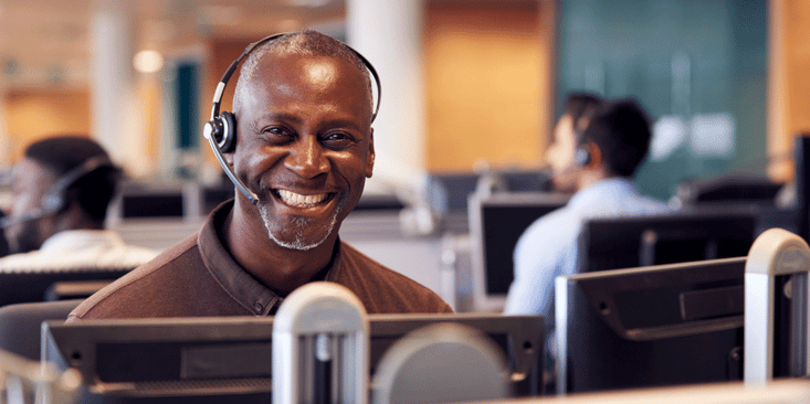 Driver recruiter with headset smiles in office, OTR truck driver pay, ATS