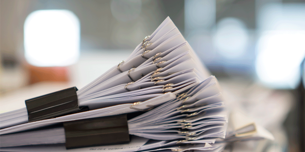 Stack of paper clipped paperwork.