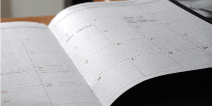 White lined planner with a calendar, load board, ATS, Anderson Trucking Service