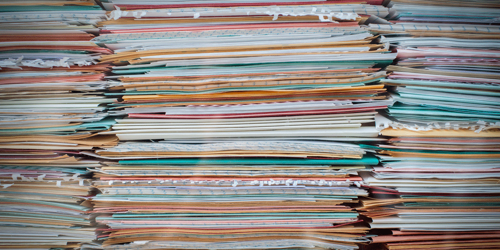 Mounds of stacked, colorful paperwork.