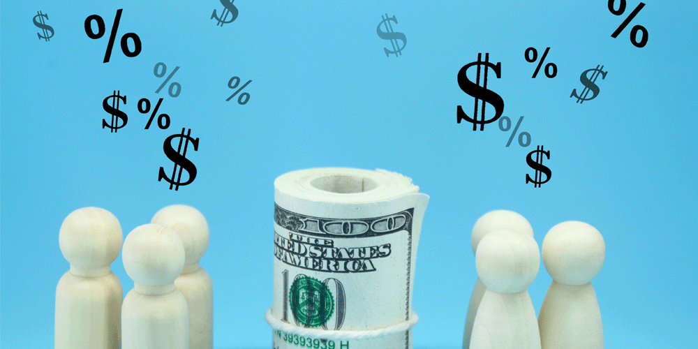 Wooden figures, a roll of $100 bills, and dollar signs and percentage symbols.