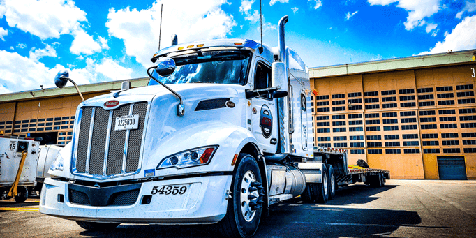 Peterbilt ATS truck parked at dock; semi-truck buying guide; Anderson Trucking Service