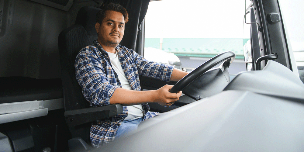 Young truck driver behind the wheel.