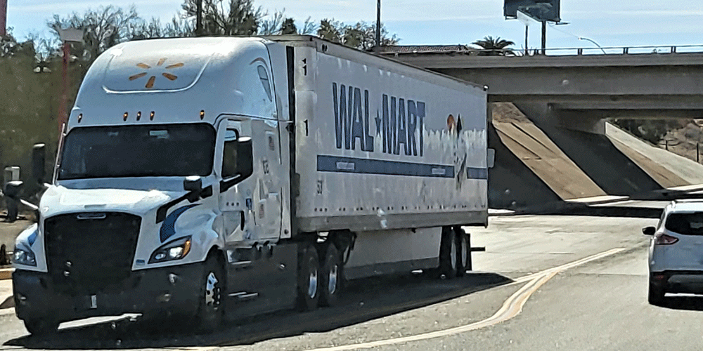 White semi with Walmart logos on the tractor and dry van.