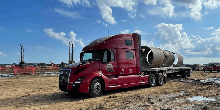 ATS semi-truck delivering oversized materials to a construction site. The best heavy haul trucking companies in 2026.