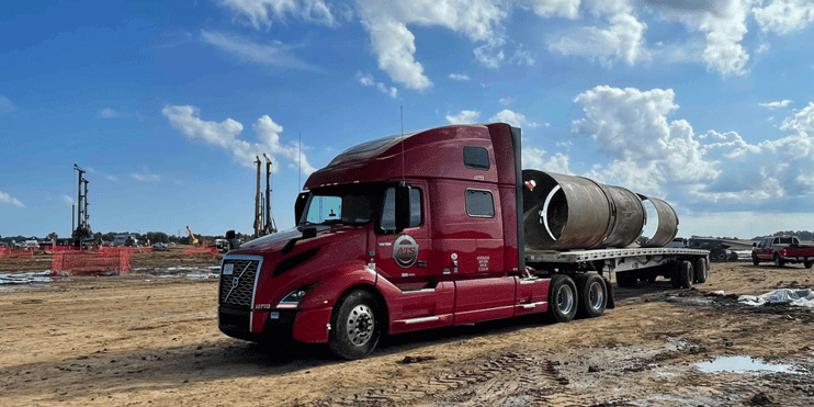 ATS semi-truck delivering oversized materials to a construction site. The best heavy haul trucking companies in 2026.