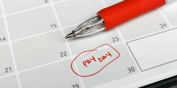 A flat desk calendar. Pay day is written in red and circle on the 30th, how to end a trucking contract, ATS, truck lease-purchase