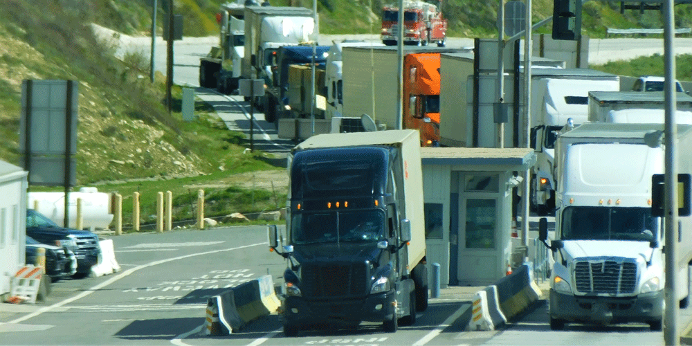 Trucks in line for inspection at a weigh station.