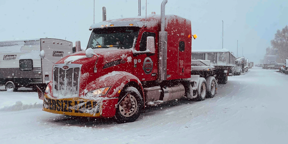 Snow-covered red truck.