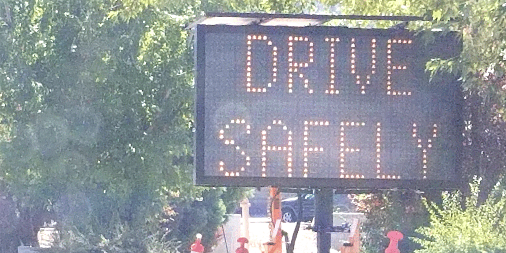 Digital sign on the side of the road that says drive safely