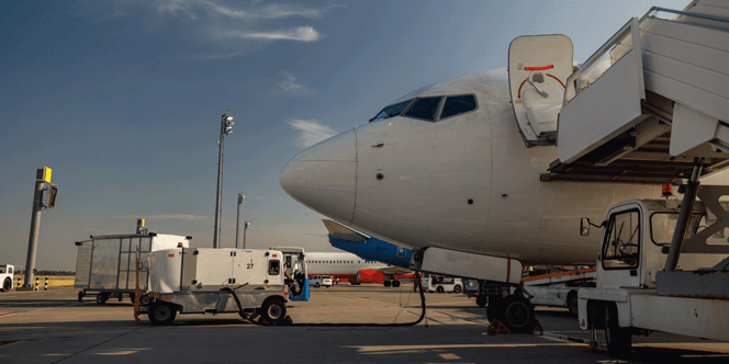 Passenger plane at airport being refueled.