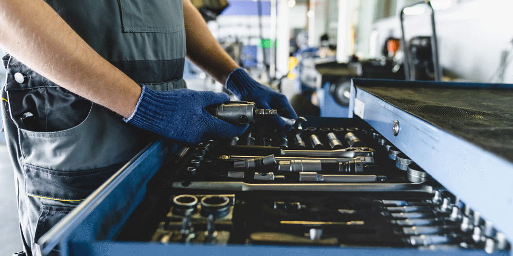 Mechanic standing at toolbox.